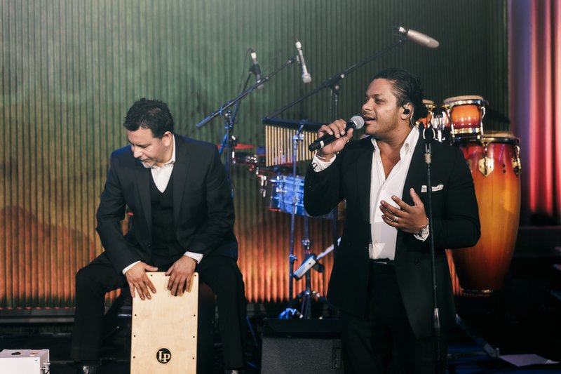 DJ and live band entertaining wedding guests on the dancefloor